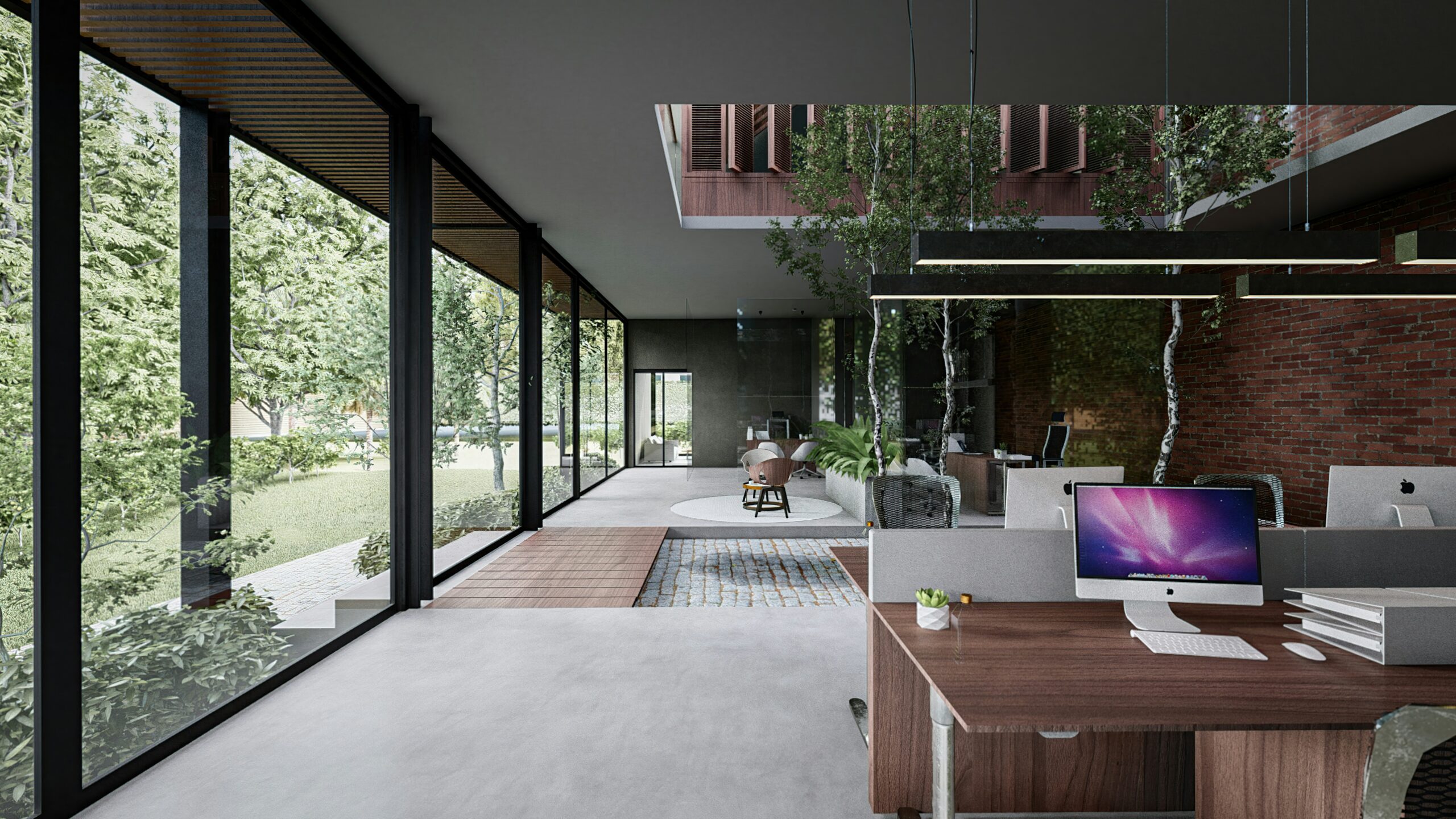 Open-plan modern office with floor-to-ceiling glass walls, greenery, and exposed brick; desks with computers in the foreground.
